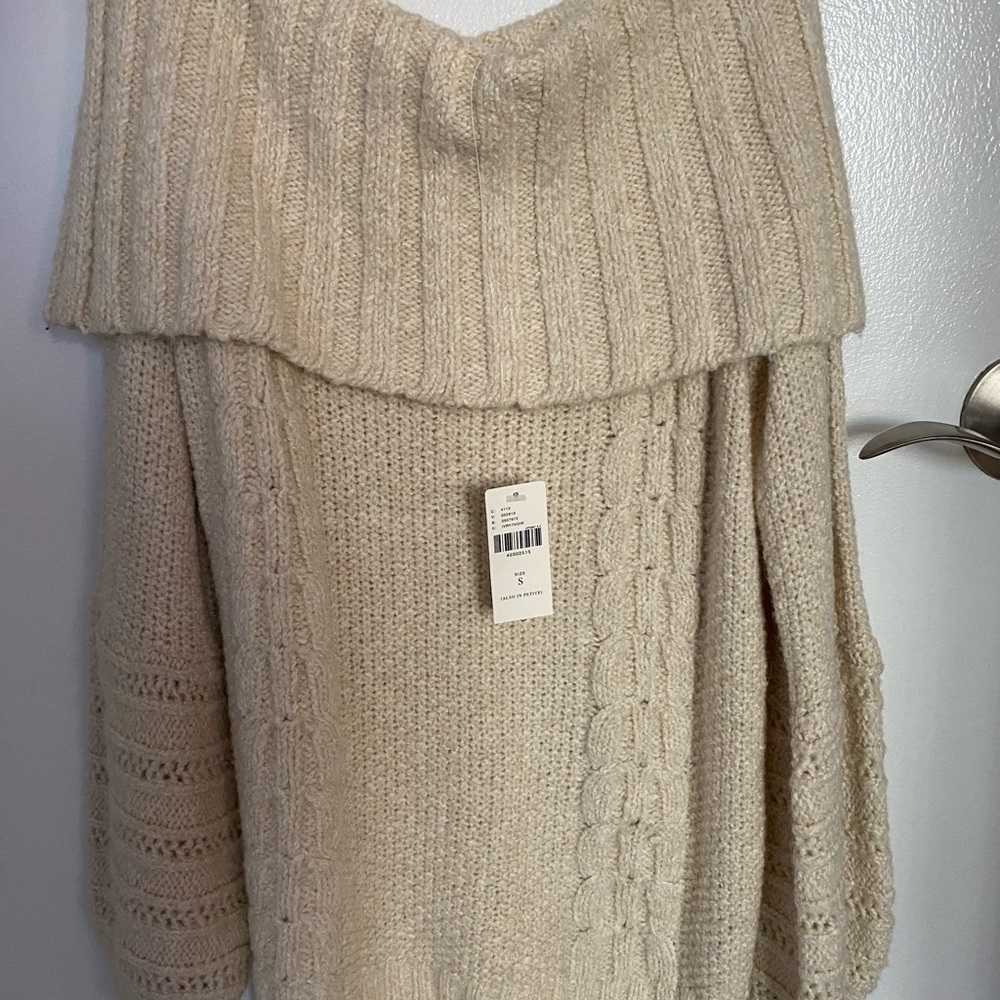 Off the shoulder ivory sweater.